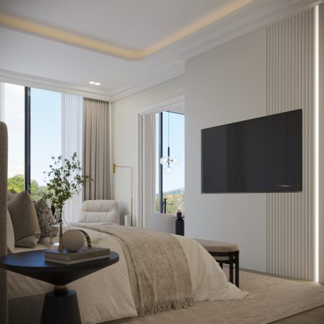 Habitación moderna y luminosa con cama, televisor y ventanas grandes.